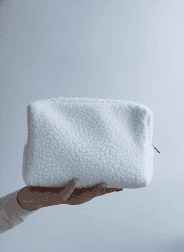 Compact shearling makeup bag with gold zipper