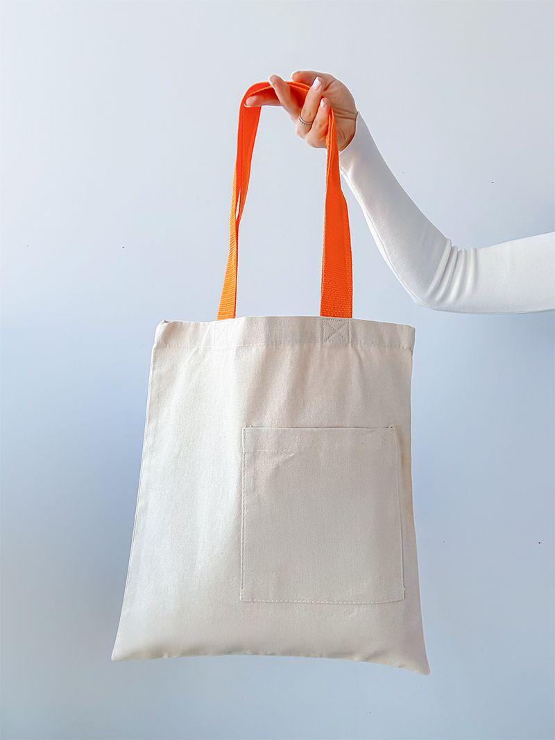 Світло-бежева натуральна сумка з кишенею та яскравими помаранчевими ручками, без друку, розмір: 38см х 42см